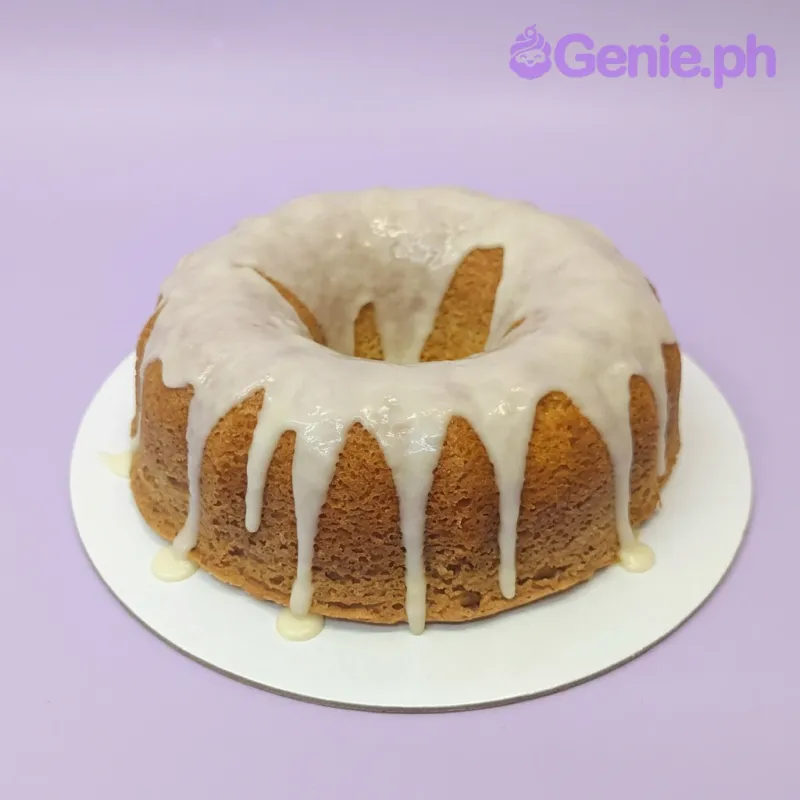 A golden-brown and white 1 Tier Bundt cake, themed Vanilla Lemon Bundt, featuring a thick white glaze dripping down the sides. A golden-brown and white 1 Tier Bundt cake, themed Vanilla Lemon Bundt, featuring a thick white glaze dripping down the sides.