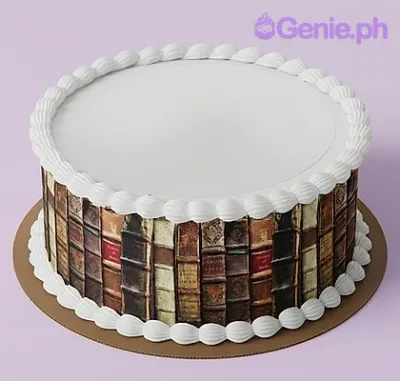 A white round cake, Vintage Book themed, featuring a vintage book spine wrap and white icing shell borders.