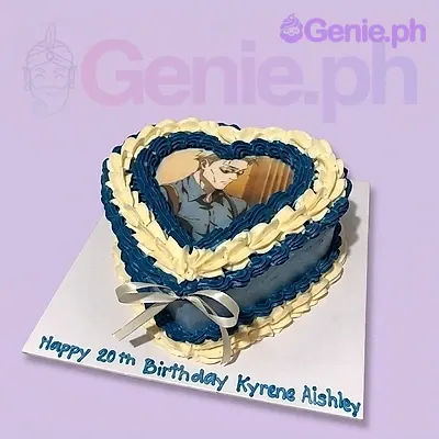 A blue and white 1-tier heart-shaped cake themed Vintage Heart, featuring a printed character image, white ribbon bow, and piped icing borders.