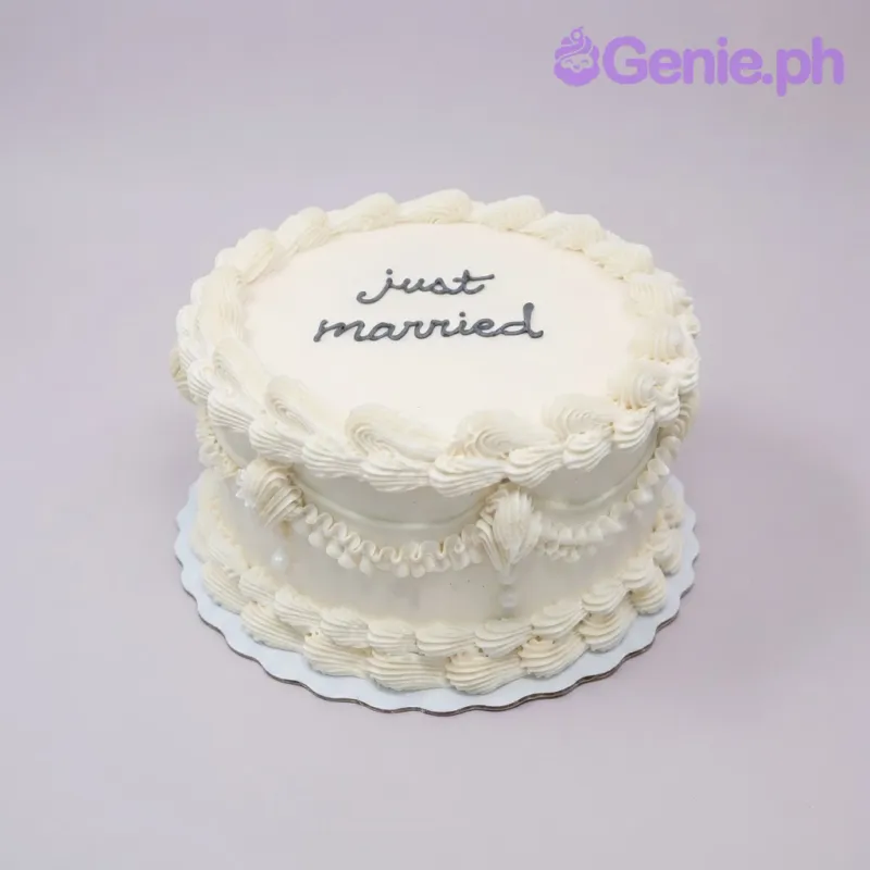White 1-tier vintage soft icing cake with piped shell borders and black piped just married script White 1-tier vintage soft icing cake with piped shell borders and black piped just married script
