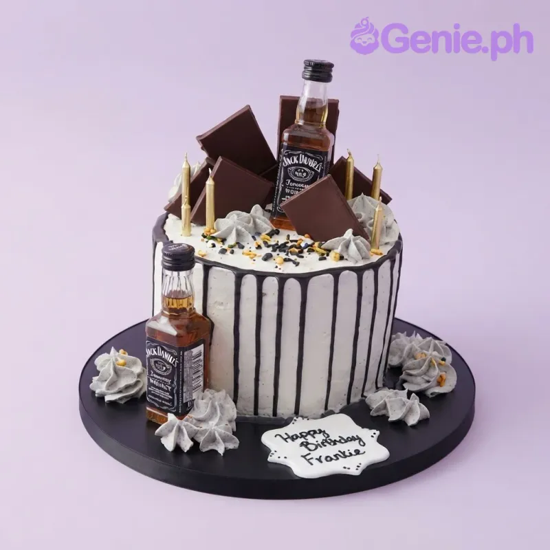 White 1 tier cake with soft icing, whiskey theme, two miniature whiskey bottle toppers, and gold taper candles White 1 tier cake with soft icing, whiskey theme, two miniature whiskey bottle toppers, and gold taper candles