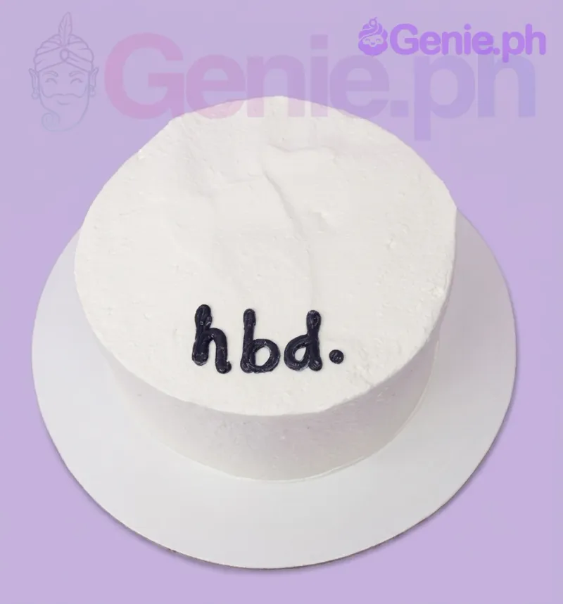 A white 1-tier cake, minimalist themed, with black piped icing text reading 'hbd.' A white 1-tier cake, minimalist themed, with black piped icing text reading 'hbd.'