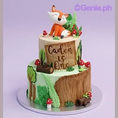 Beige 2-tier woodland themed cake with a 3D fox topper and forest decorations Beige 2-tier woodland themed cake with a 3D fox topper and forest decorations