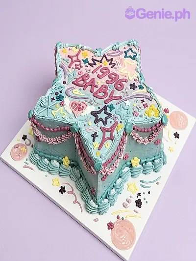 Light blue star-shaped cake with piped Y2K style decorations and 1996 BABY message Light blue star-shaped cake with piped Y2K style decorations and 1996 BABY message
