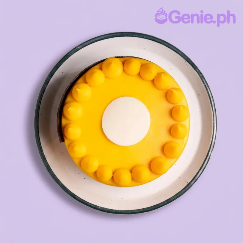 A yellow and white 1 Tier cake themed around minimalism, featuring a white circular fondant center and a ring of yellow icing dollops. A yellow and white 1 Tier cake themed around minimalism, featuring a white circular fondant center and a ring of yellow icing dollops.