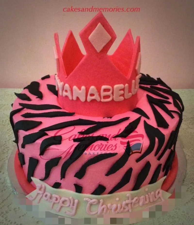 Pink 1-tier fondant cake with black zebra stripes and a large pink fondant crown topper. Pink 1-tier fondant cake with black zebra stripes and a large pink fondant crown topper.