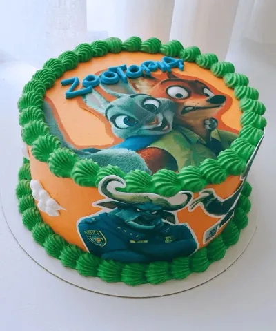 An orange 1-tier Zootopia cake, featuring Judy Hopps, Nick Wilde, Chief Bogo printouts, green borders, white clouds. An orange 1-tier Zootopia cake, featuring Judy Hopps, Nick Wilde, Chief Bogo printouts, green borders, white clouds.