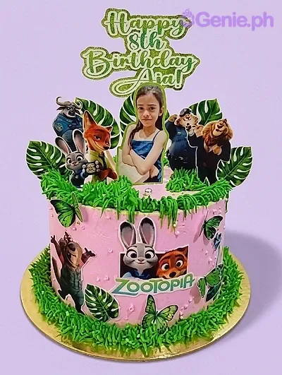 Pink Zootopia themed birthday cake with green icing grass, character printouts, and a personalized photo topper for Ana's 8th birthday. Pink Zootopia themed birthday cake with green icing grass, character printouts, and a personalized photo topper for Ana's 8th birthday.