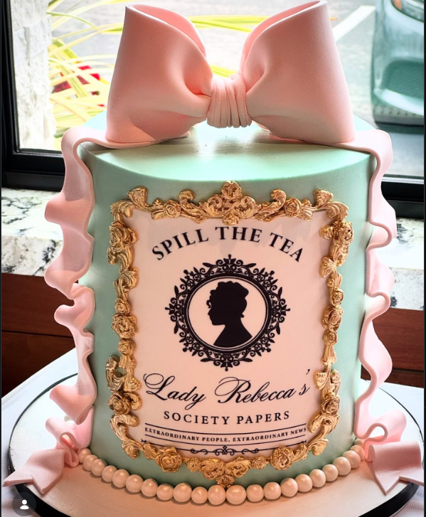 Mint green 1-tier fondant cake with a large pink gumpaste bow and a Lady Whistledown society paper printout in a gold frame