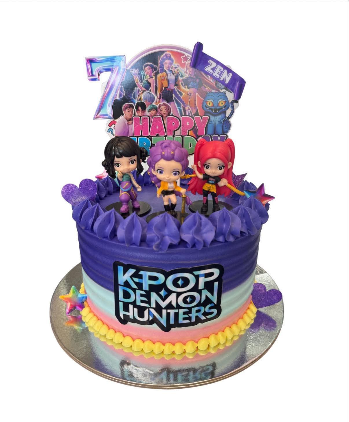 A 6-inch 1-tier purple gradient cake featuring K-Pop character figurines, a circular backdrop topper, a stylized number 7, and a yellow bead border. A 6-inch 1-tier purple gradient cake featuring K-Pop character figurines, a circular backdrop topper, a stylized number 7, and a yellow bead border.