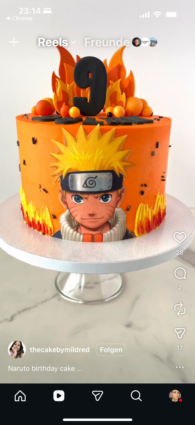 A photo of a Naruto themed cake. It is a 1 Tier cake decorated with a Naruto character cutout, a black number 9, orange and yellow gumpaste flames, and colorful gumpaste balls.