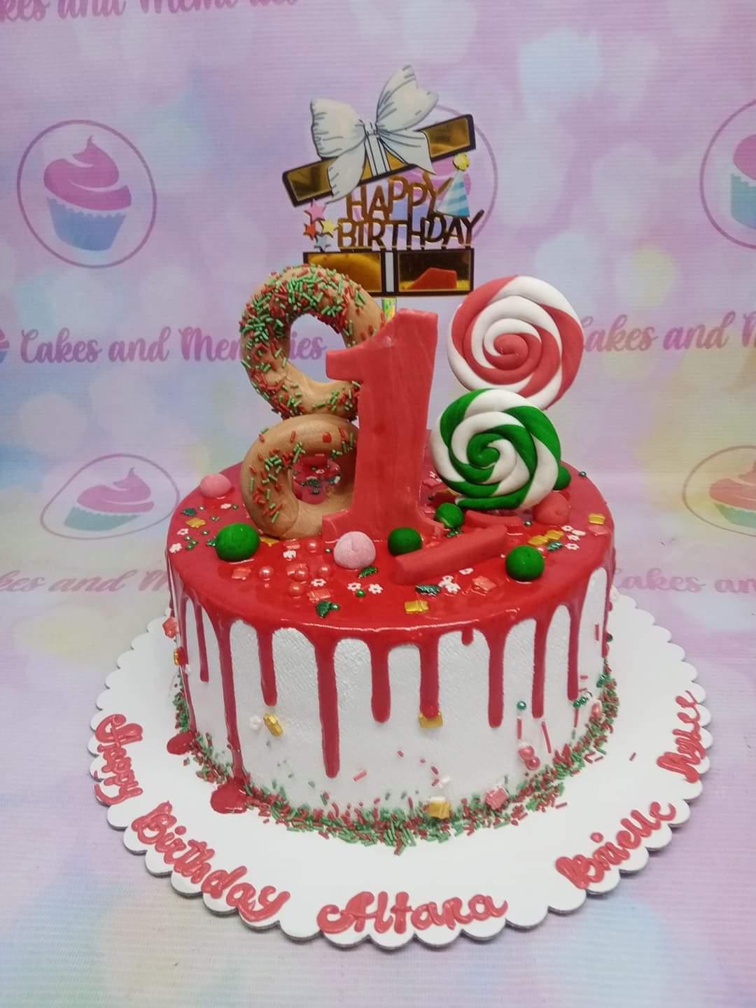 White 1-tier birthday cake with red drip, donuts, lollipops, and a large red number 18 topper.