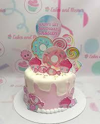 1st birthday sweets 1 Tier - colorful theme with Happy 1st Birthday Cassidy round topper and donut cutouts