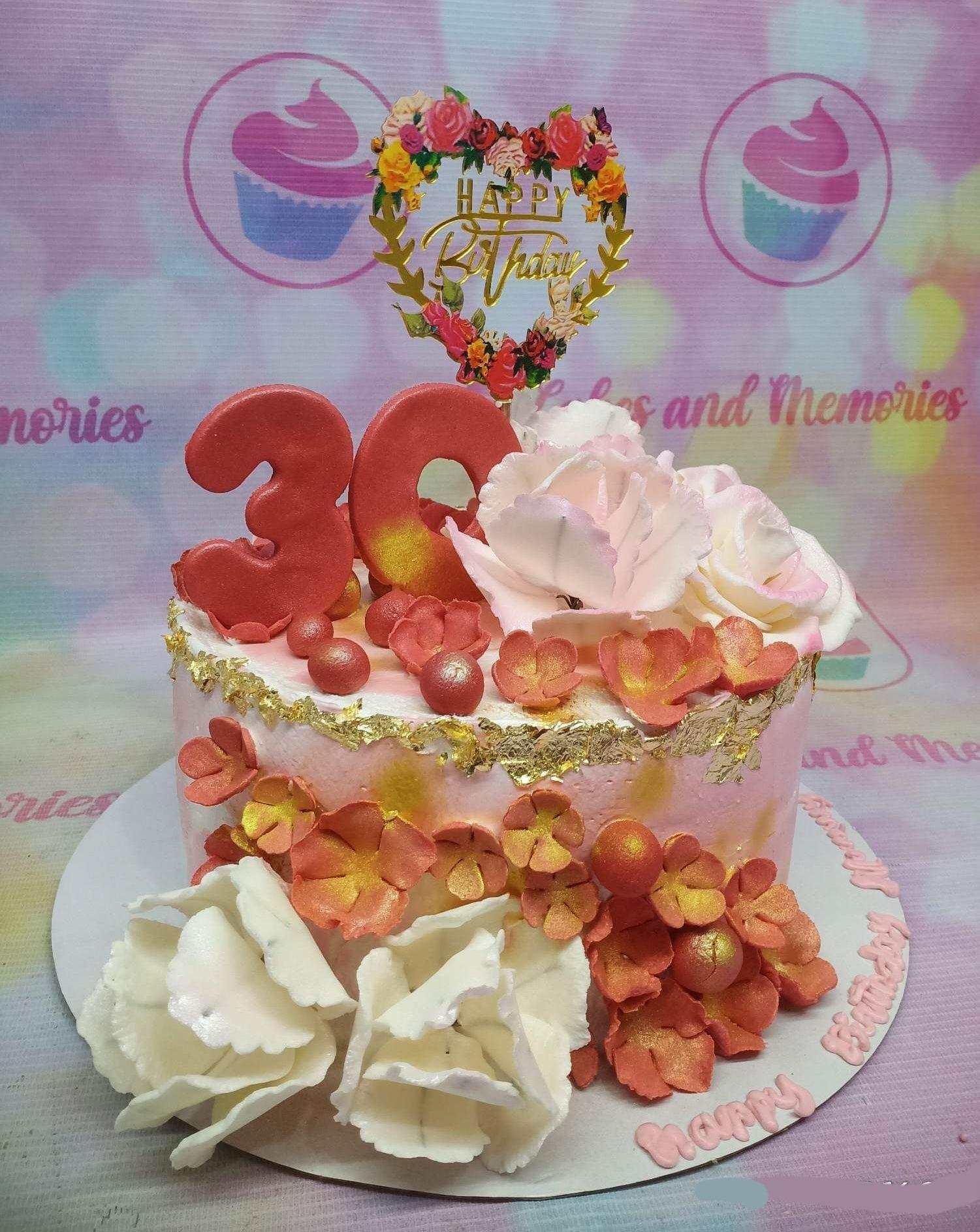 Pink 1-tier birthday cake with large pink and white gumpaste roses, gold leaf accents, and a red number 30 topper.