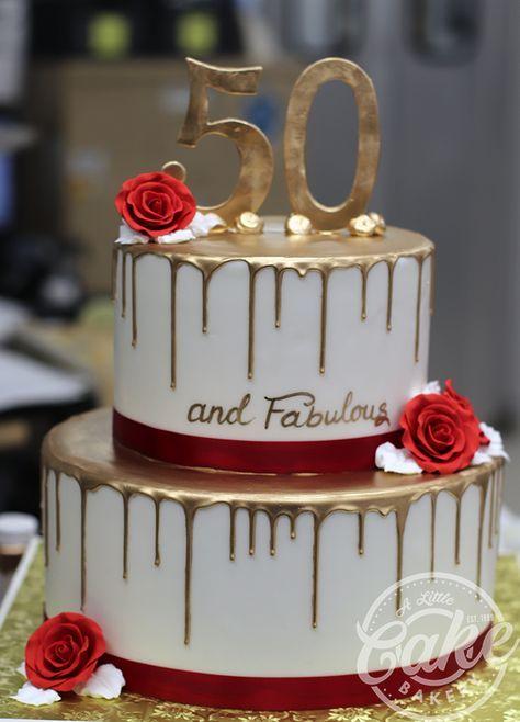 Elegant 2-tier white cake with gold drip, red roses, and a gold 50 and fabulous topper.