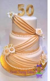Cake 3 Tier Fondant - gold, white, cream theme with number 50 and draped gold fabric-like panels