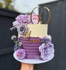 Elegant purple and cream textured cake with large lavender silk flowers and a gold 60 topper.