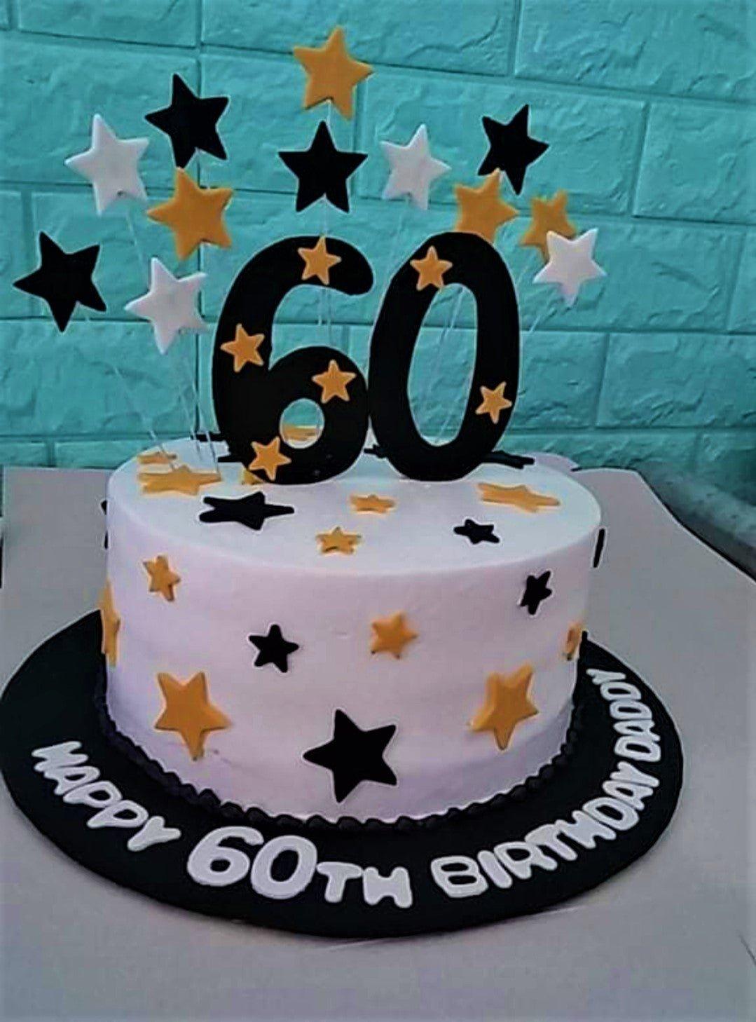 White 1-tier 60th birthday cake for Daddy featuring black and gold fondant stars and a large black number 60 topper.