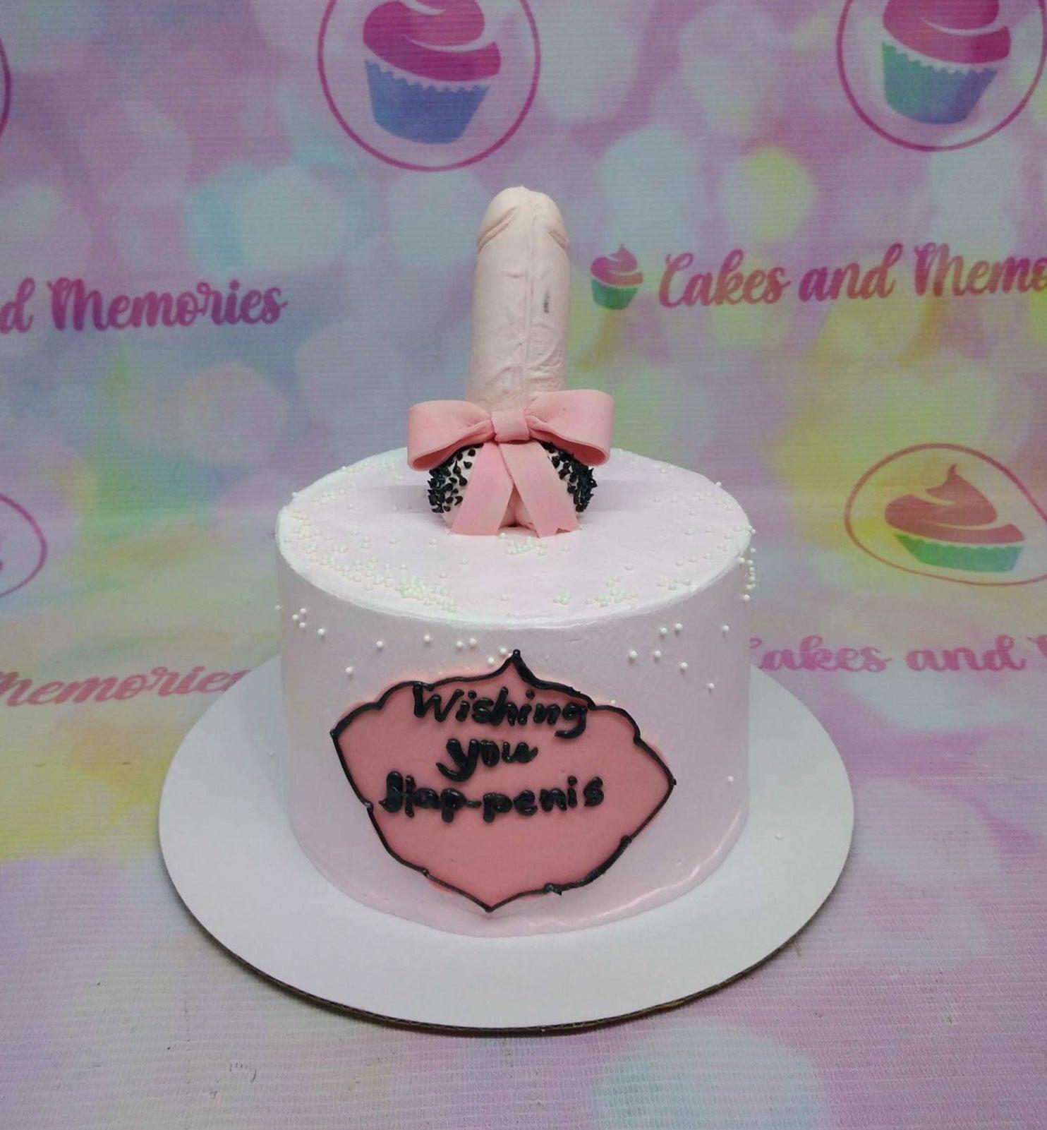 Pink minimalist cake with a humorous 3D fondant topper and a message plaque on the side.