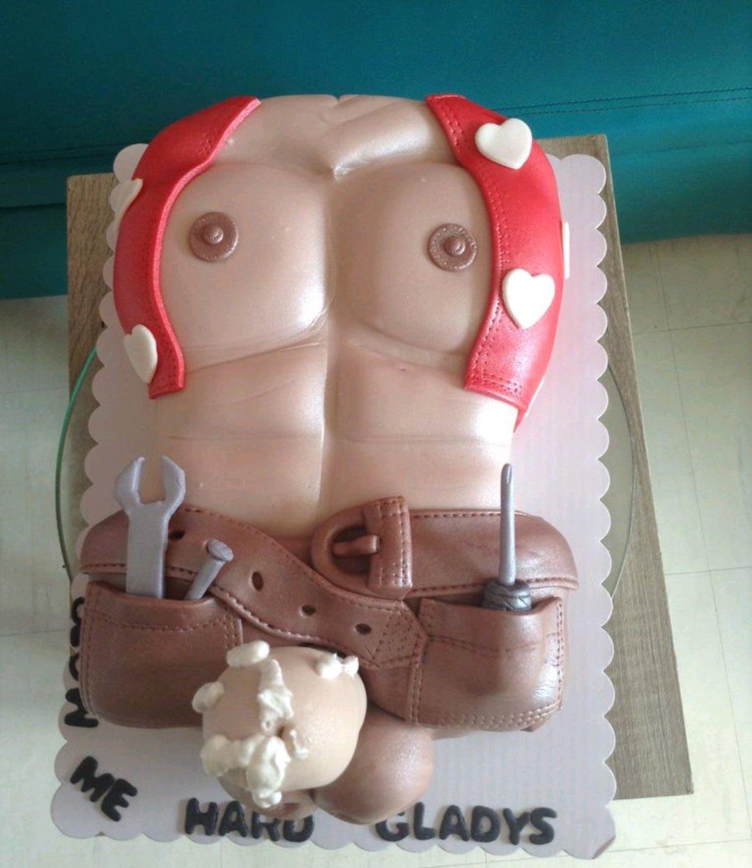 Adult themed torso cake featuring a muscular male chest with a red vest, tool belt, and humorous fondant details.