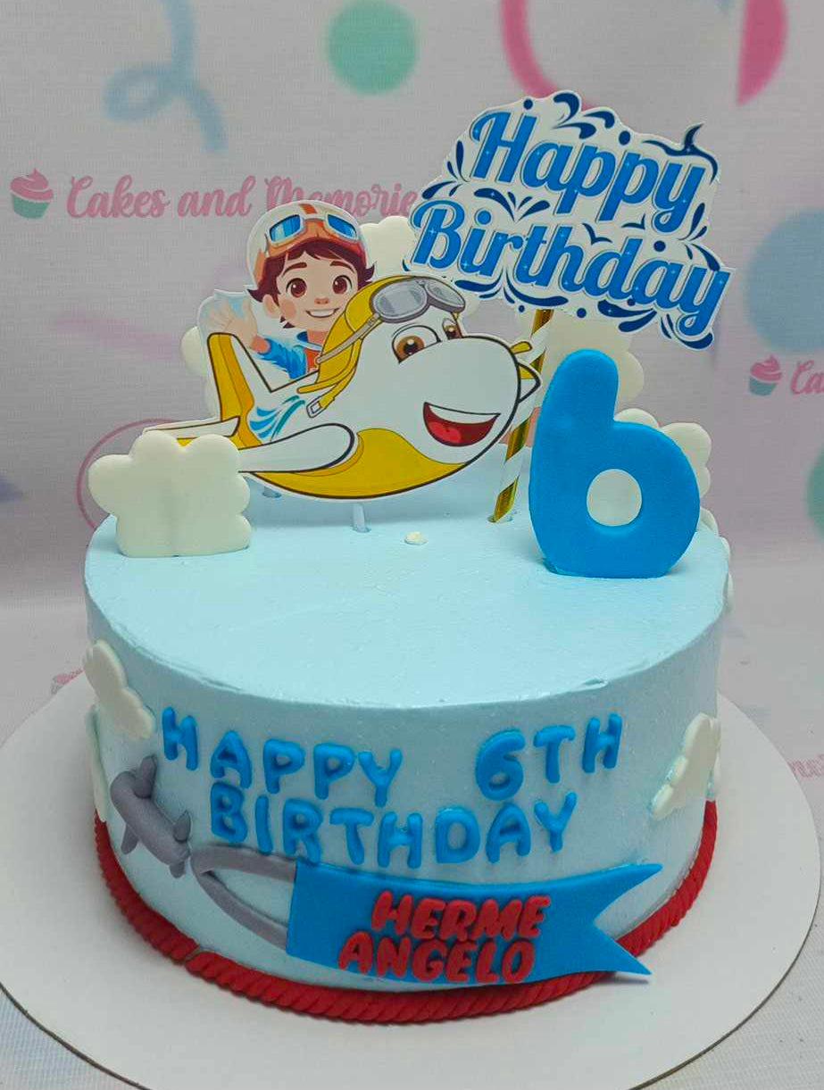 Light blue airplane themed birthday cake with a pilot character printout, white fondant clouds, and a blue number 6 topper.