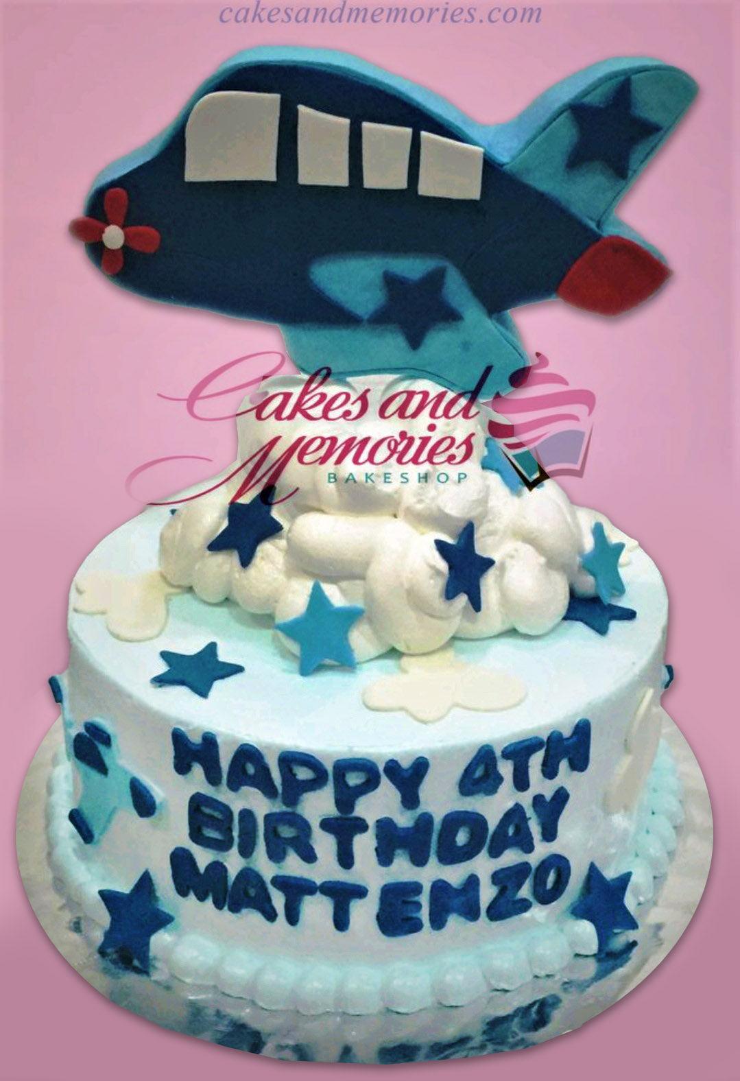 Light blue 1-tier airplane birthday cake with white fondant clouds and dark blue stars for Matt Enzo's 4th birthday.