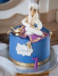 Blue Aladdin themed cake with a 3D fondant Prince Ali figure sitting on a purple magic carpet with a gold magic lamp.