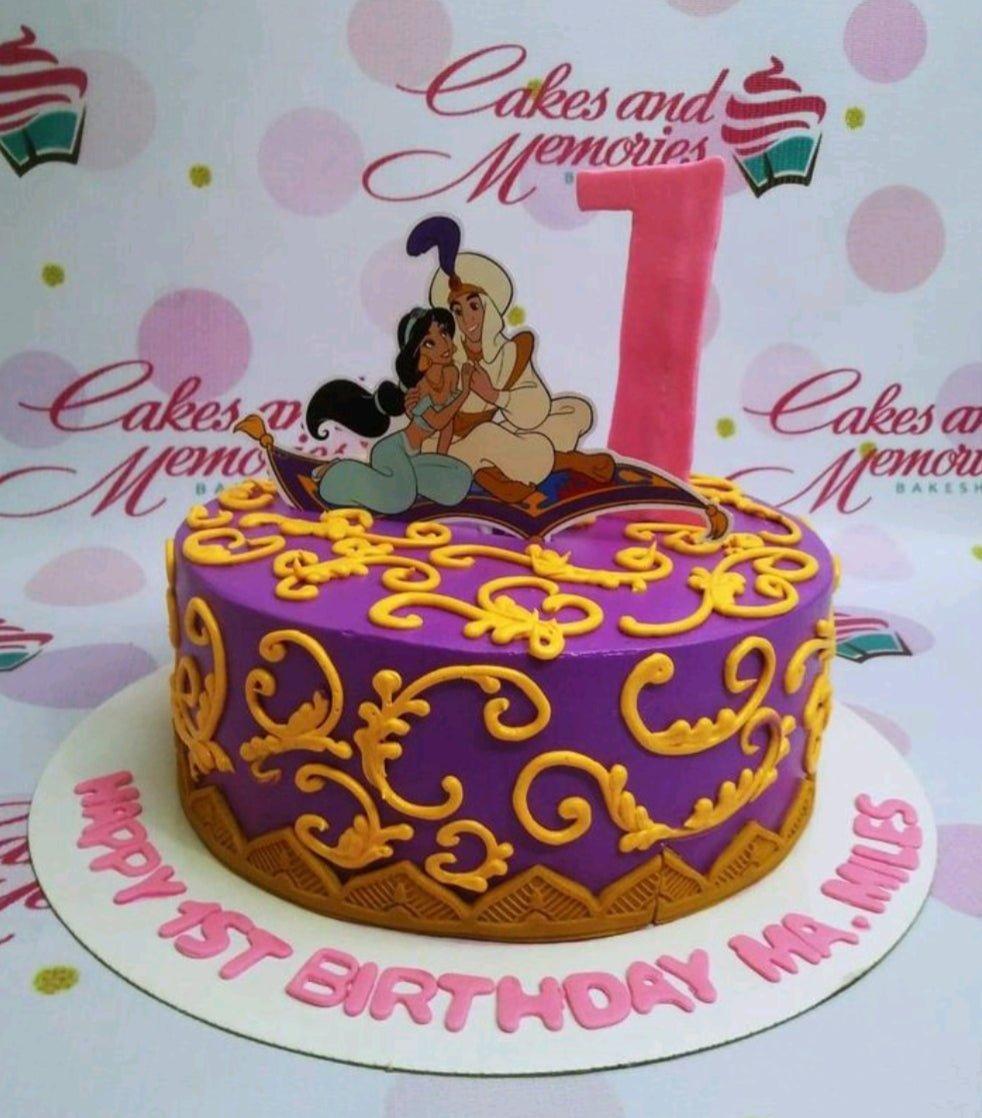 Purple Aladdin and Jasmine themed birthday cake with gold scrollwork and a large pink number one topper.