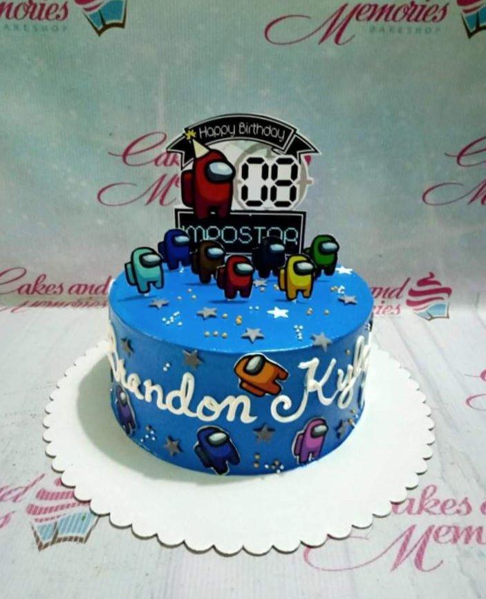 Blue Among Us themed birthday cake with character printouts, silver stars, and a personalized name message.