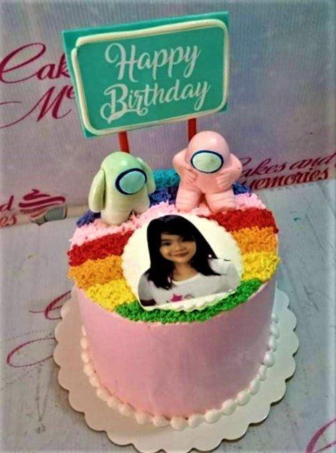 Pink Among Us themed birthday cake with rainbow textured icing, edible photo print, and 3D character toppers.