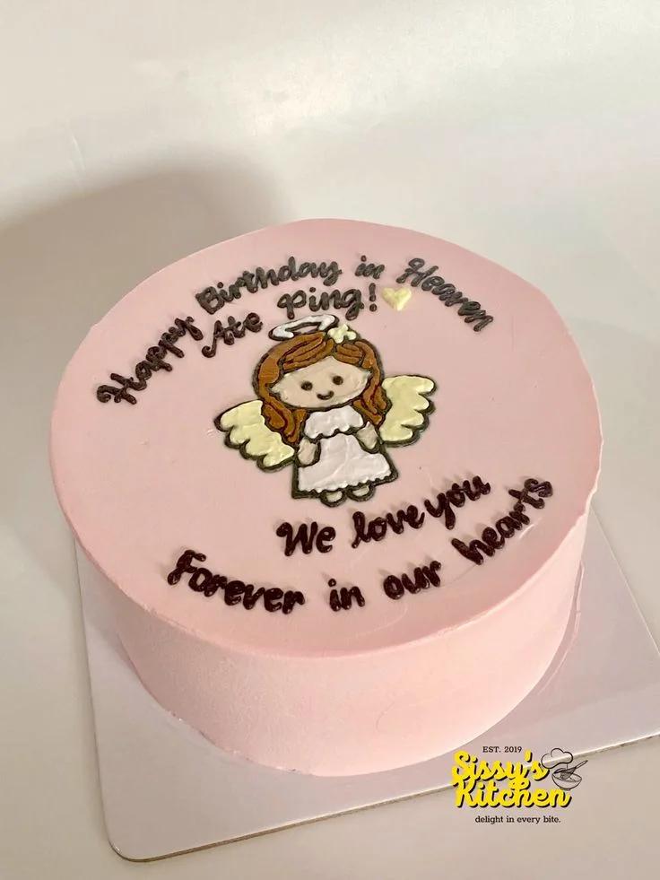 Pink bento cake with a hand-piped angel character and a heartfelt message for a birthday in heaven.