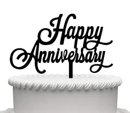 White minimalist cake with a large black Happy Anniversary cardstock topper and white icing border.