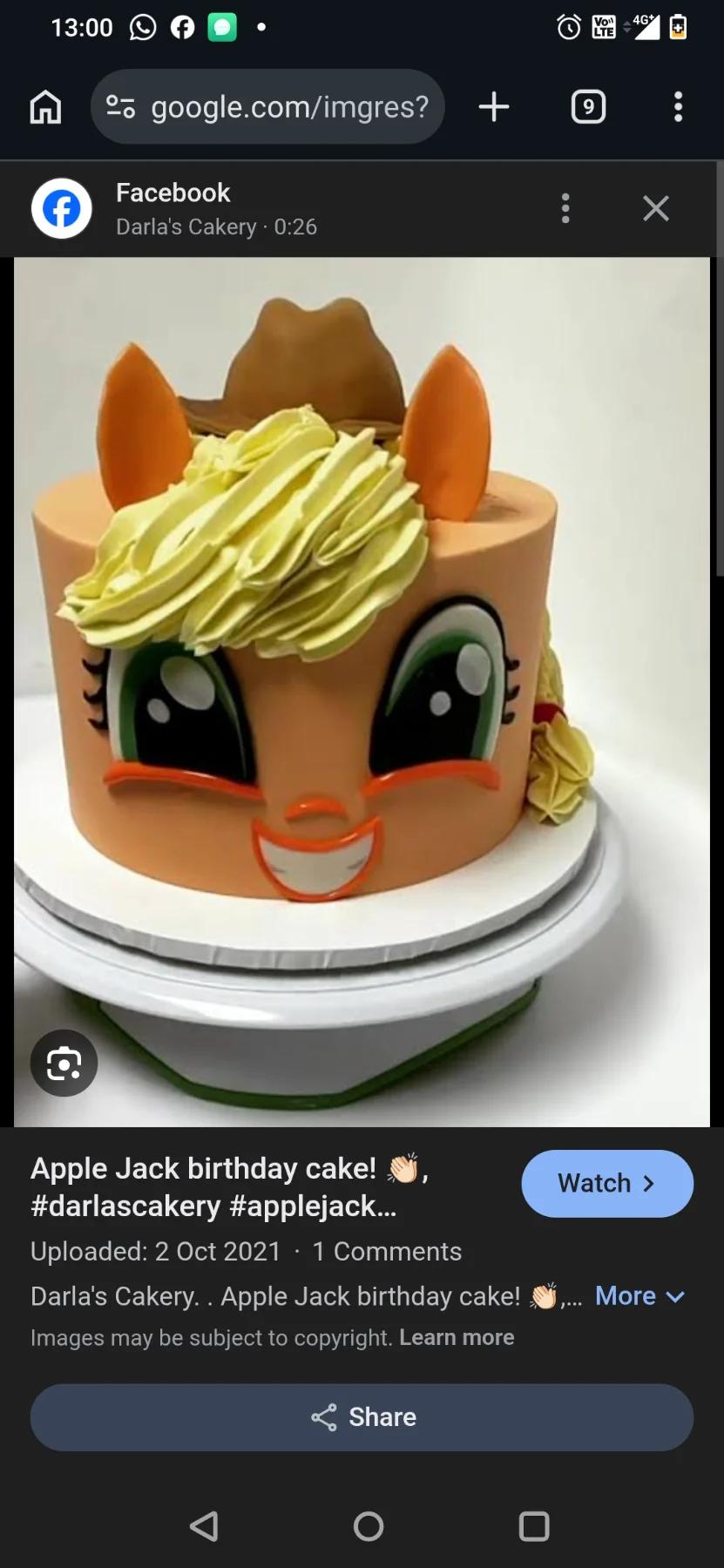 Applejack My Little Pony character cake with orange icing, yellow piped hair, and fondant facial features.