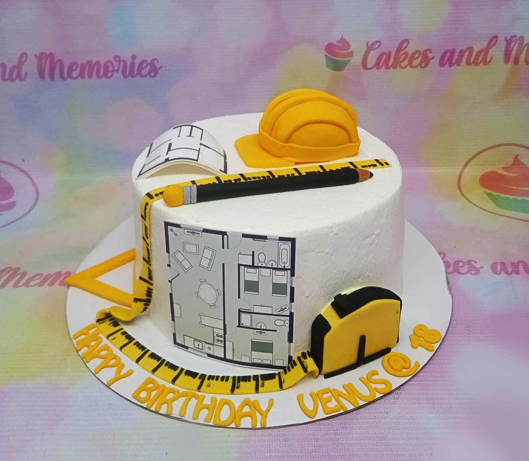 White architect themed birthday cake with yellow hard hat, blueprint, measuring tape, and pencil toppers.