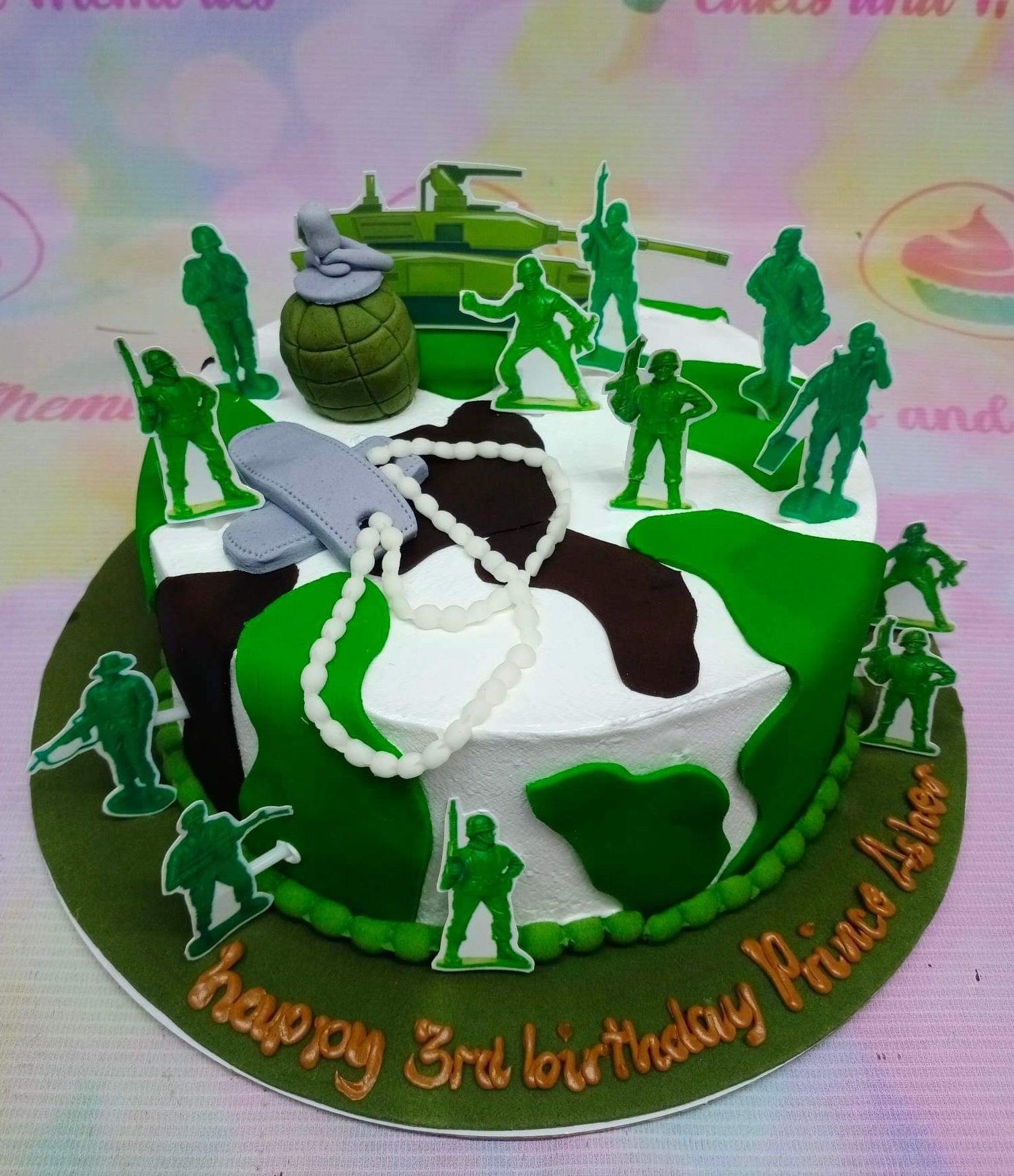 Army themed camouflage cake with green soldier printouts, a fondant grenade, and dog tags for a 3rd birthday.