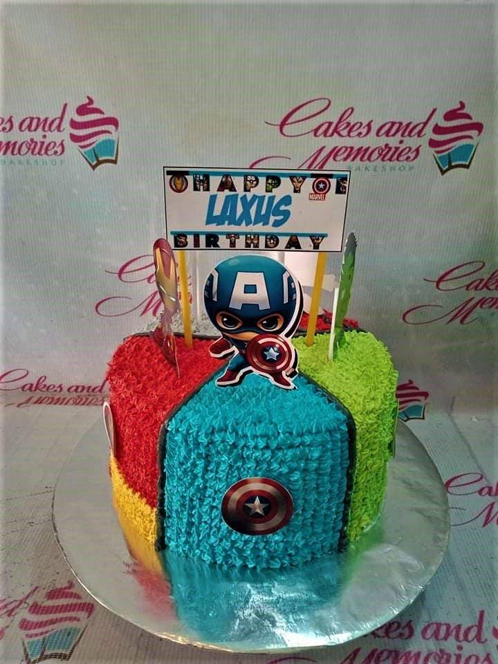 Avengers themed birthday cake with Captain America, Iron Man, and Hulk toppers on a multi-colored textured icing base.