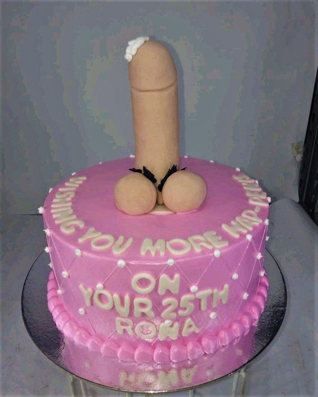 Pink bachelorette cake with a large flesh-colored fondant phallic topper and white icing message.