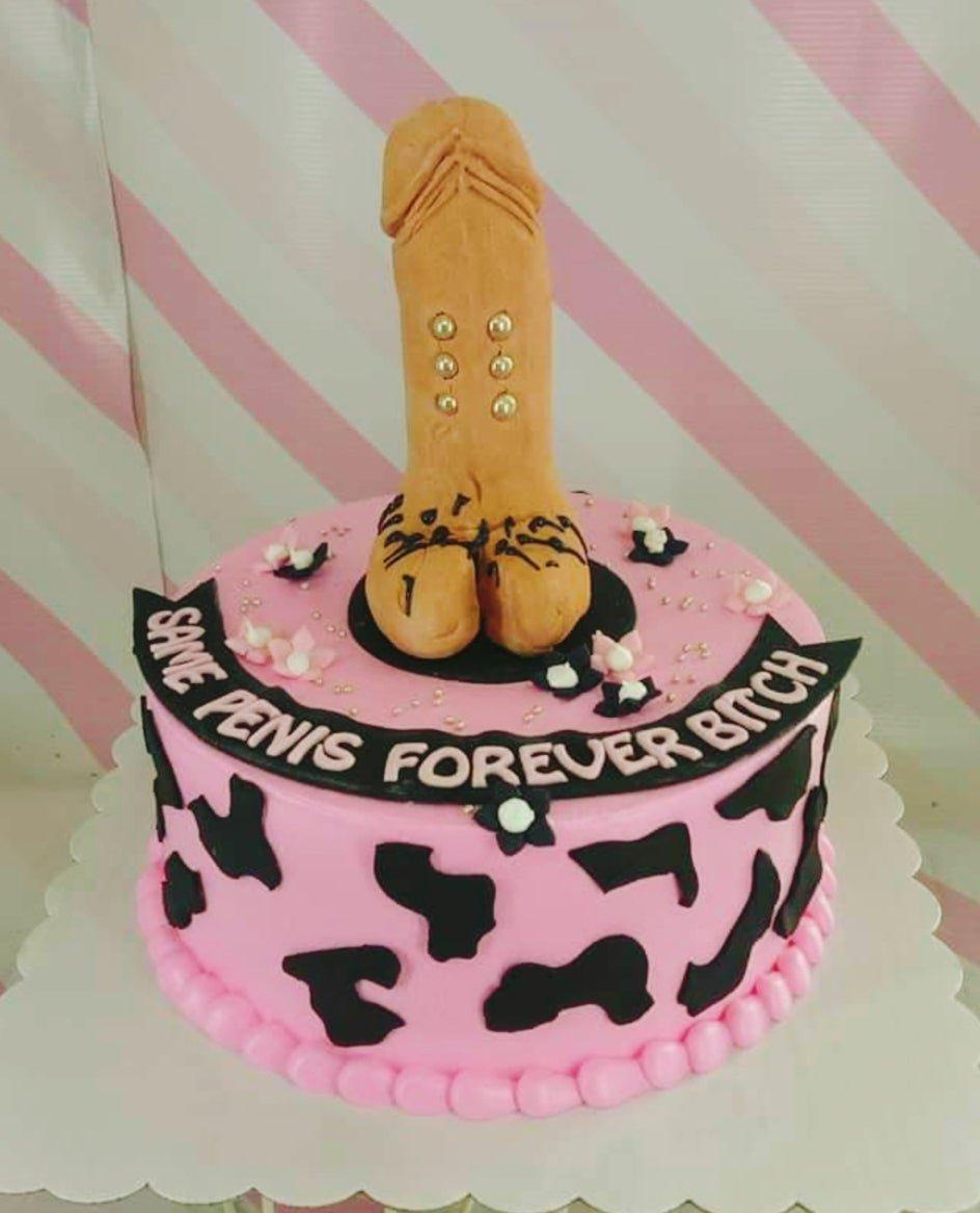Pink bachelorette cake with a large tan phallic topper, black cow print patterns, and a black banner with pink text.