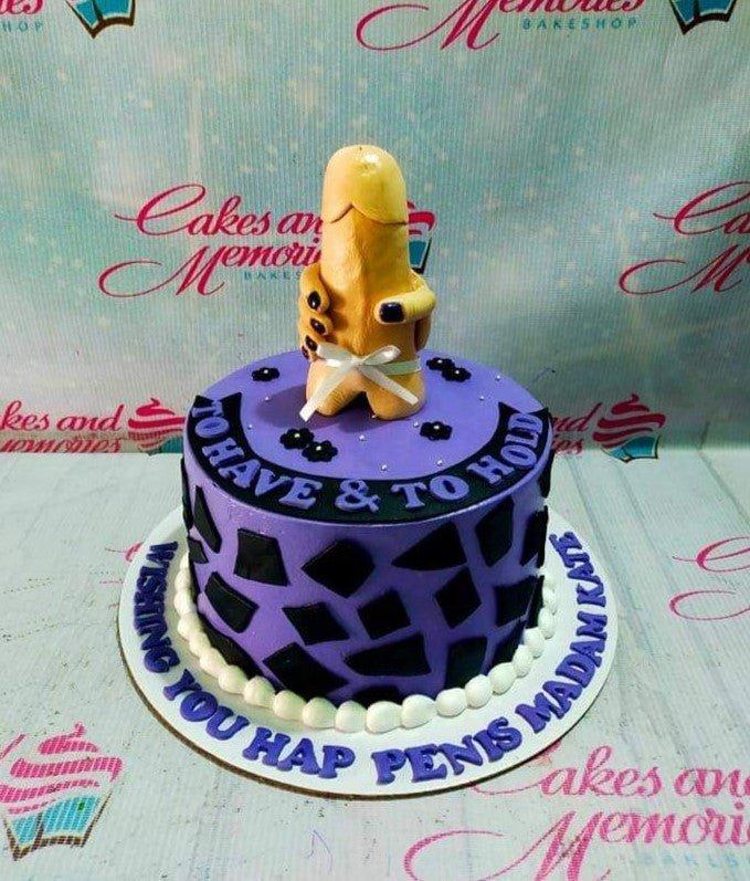 Purple bachelorette cake with a humorous 3D fondant figure, black geometric patterns, and a white pearl border.