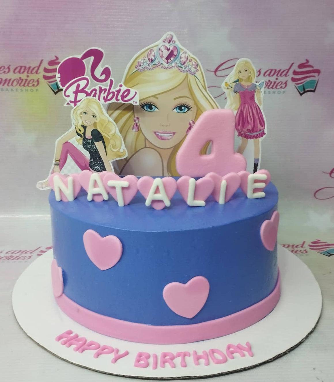 Blue Barbie themed birthday cake with pink heart decorations and Barbie character printouts.