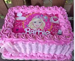 Pink Barbie rectangle cake with a large Barbie printout topper and pink icing rosettes