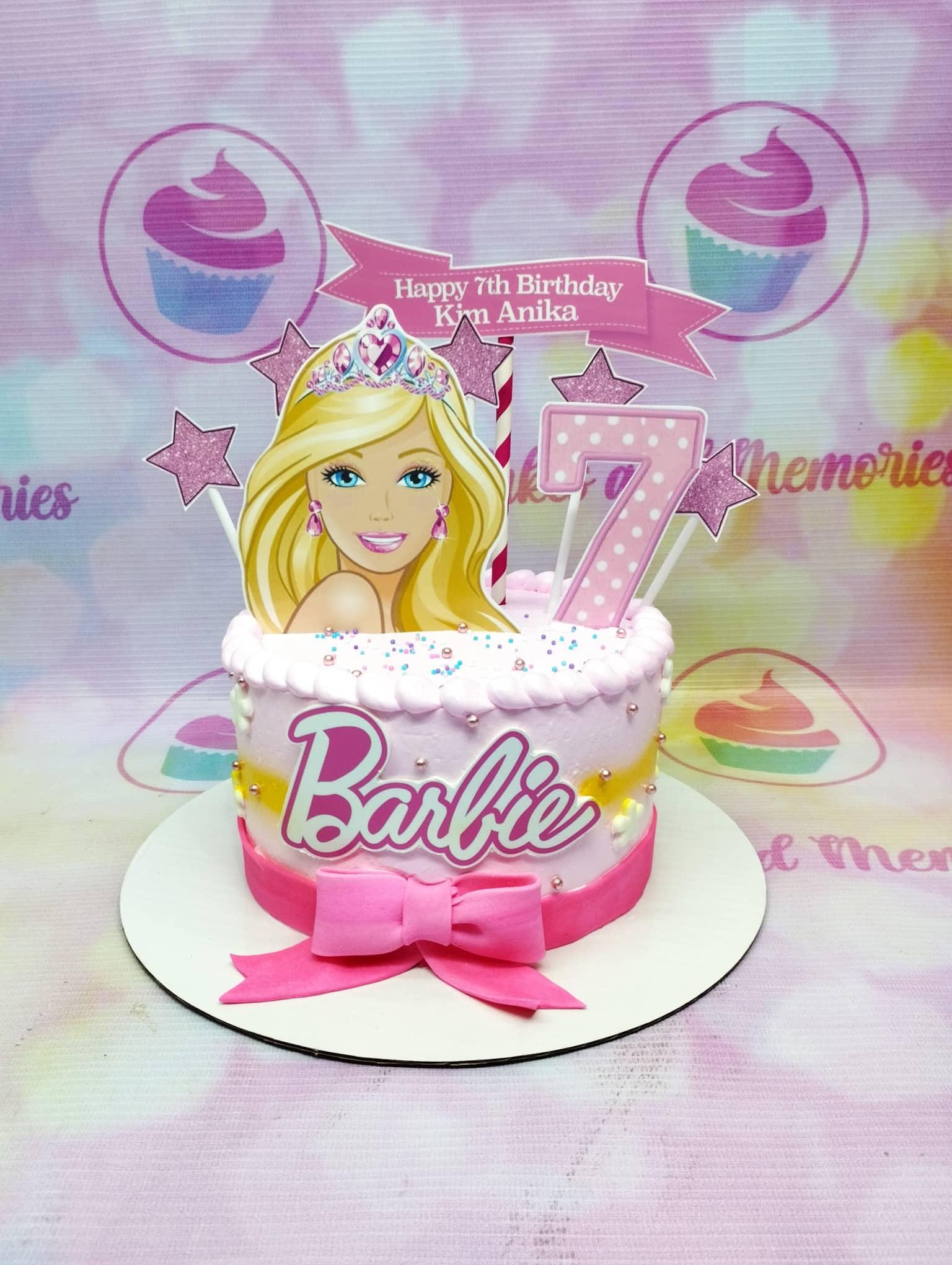 Pink Barbie themed birthday cake with a large Barbie printout topper, pink glitter stars, and a pink fondant bow.