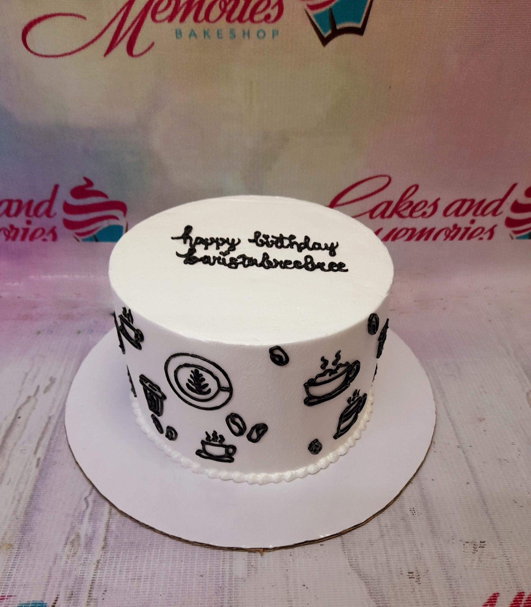 White minimalist cake with black hand-drawn coffee icons and a birthday message for a barista.