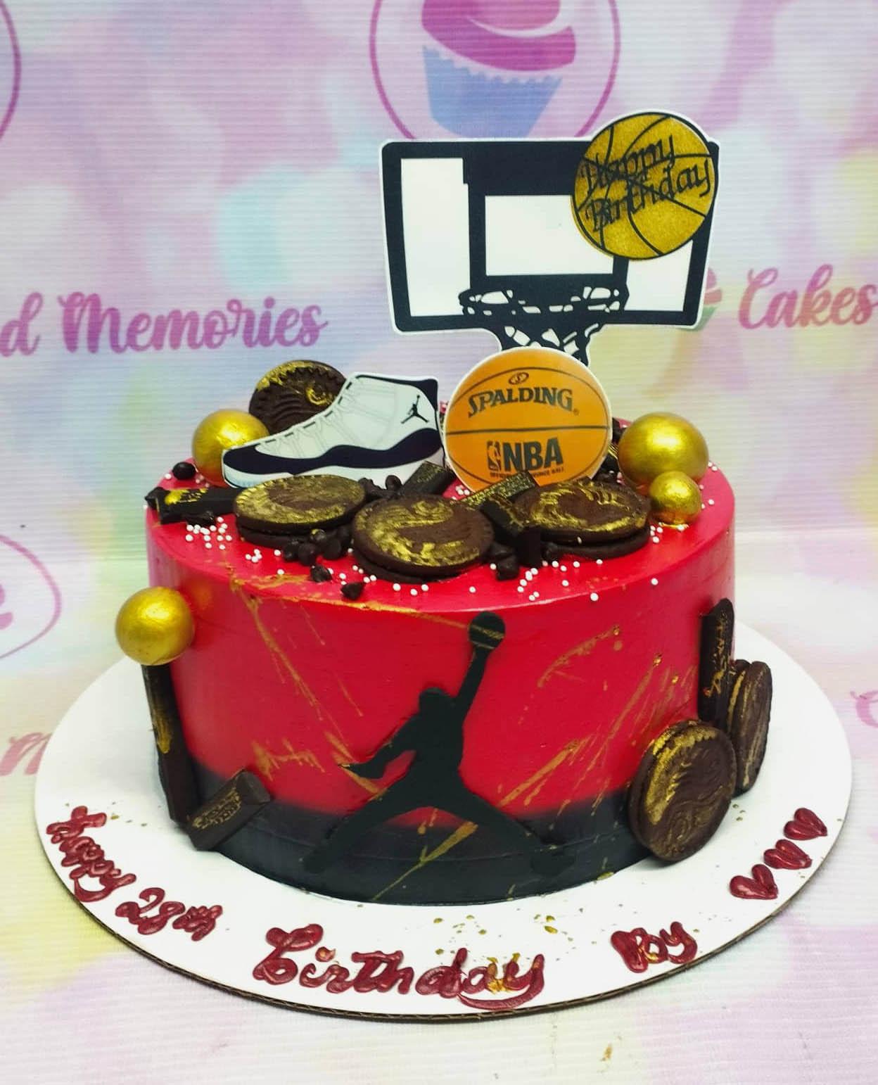 Red and black basketball themed cake with Jordan silhouette, basketball hoop topper, and gold-dusted chocolate cookies.