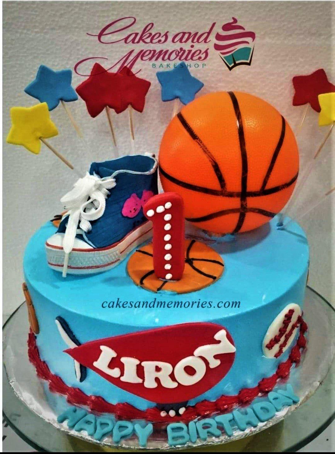 Blue basketball and sports themed birthday cake with a 3D sneaker, basketball, and star toppers.