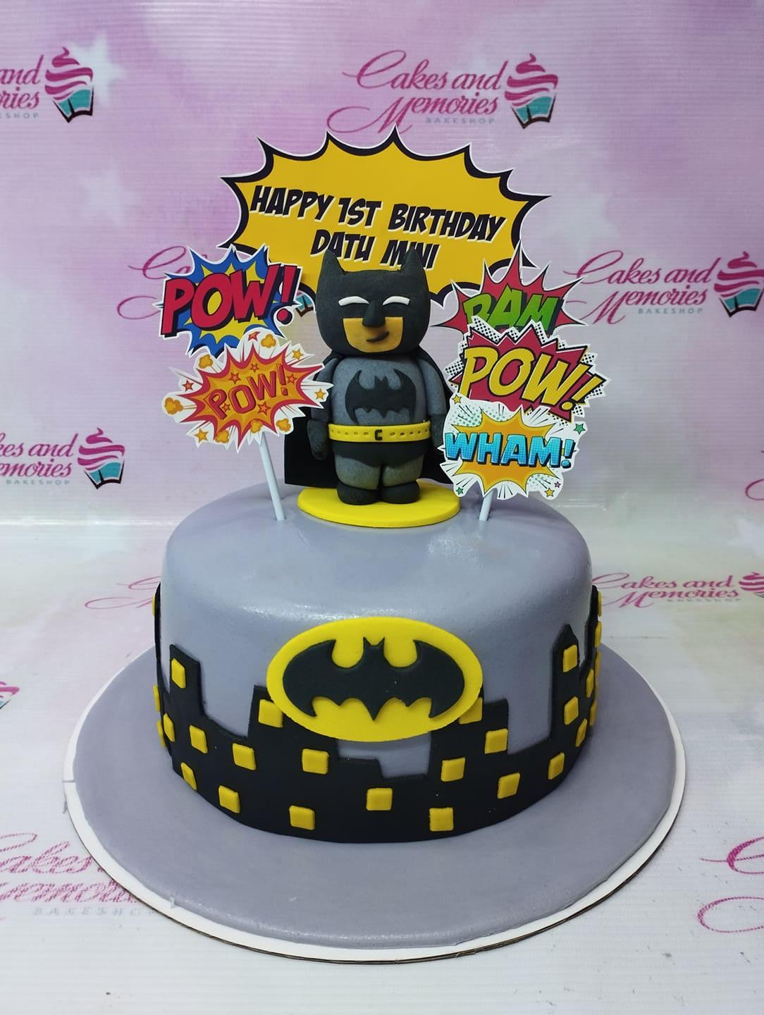 Lego Batman themed 1-tier gray fondant cake with city skyline and comic book action toppers