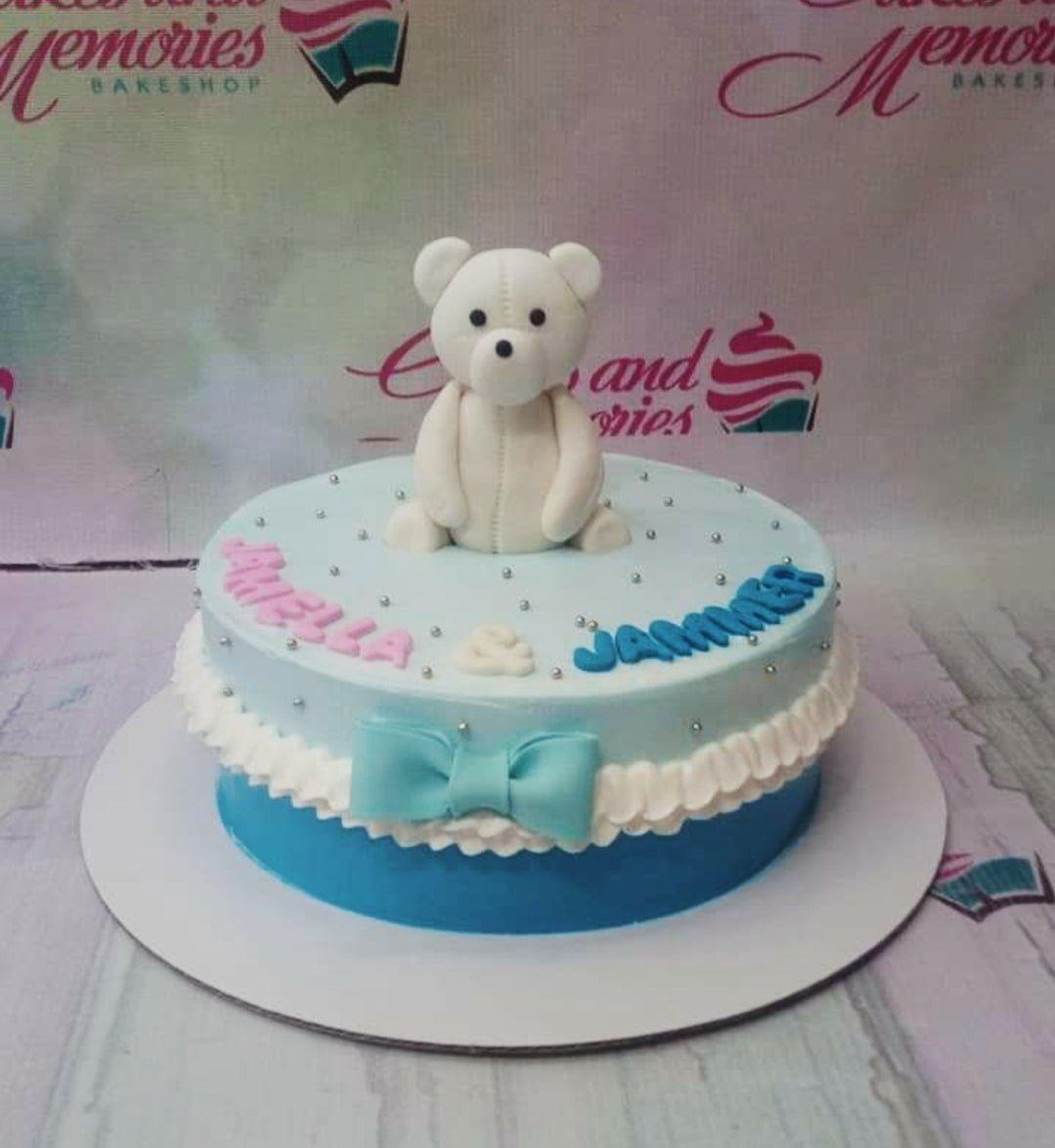 Light blue 1-tier birthday cake with a white fondant bear topper, blue bow, and silver dragees.