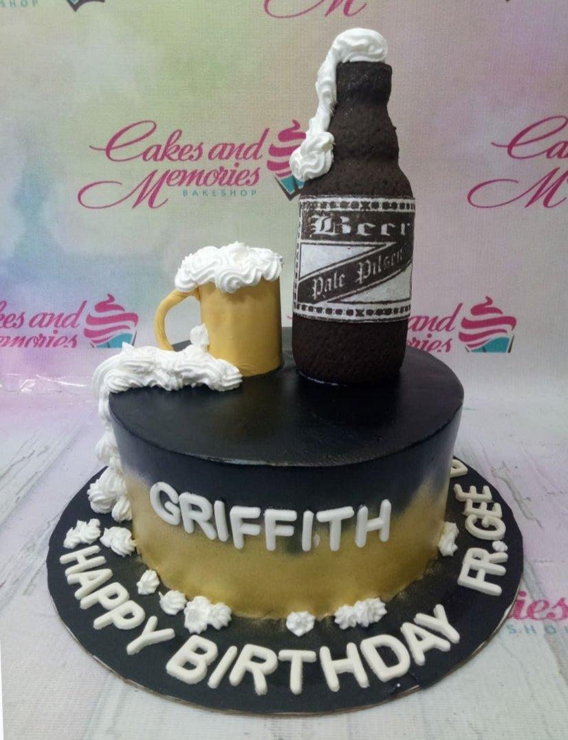 Black and gold beer themed birthday cake with a 3D fondant beer bottle and mug with white icing foam.