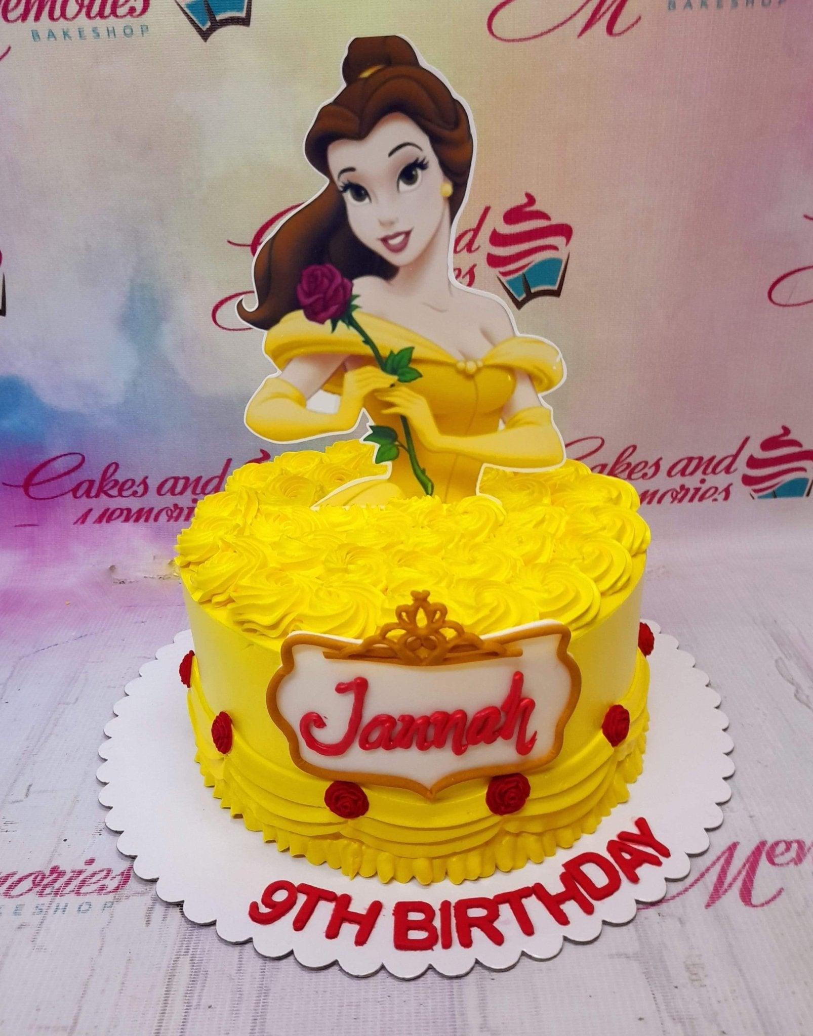 Yellow Belle Disney Princess birthday cake with piped icing rosettes and a large character printout topper.