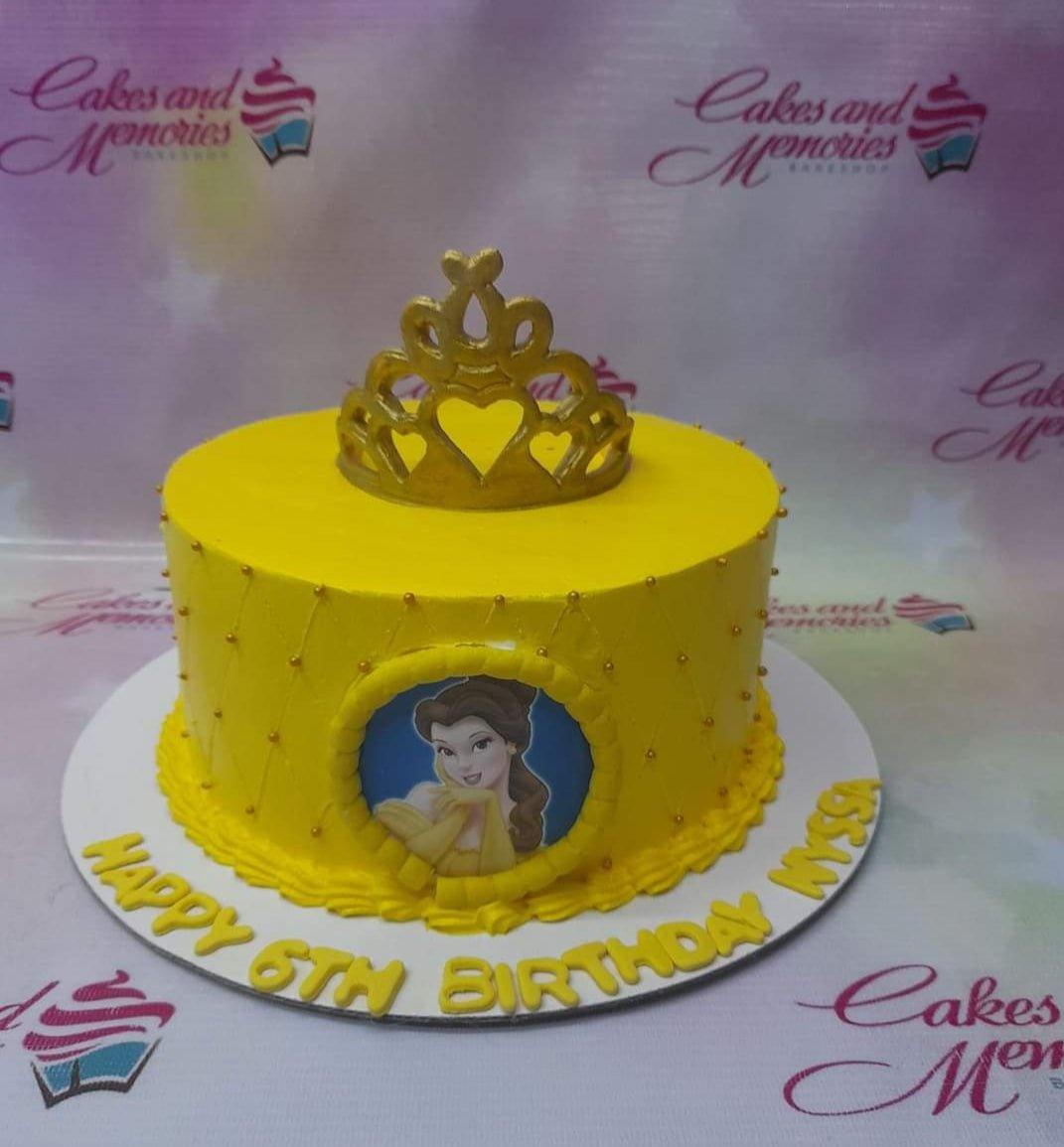 Yellow Belle Disney Princess birthday cake with a gold tiara and quilted icing pattern with gold beads.